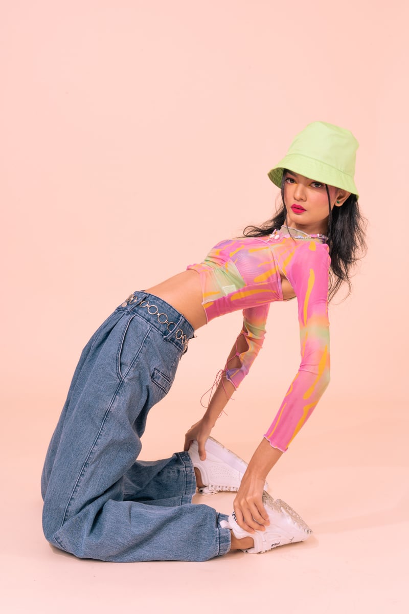 Woman in Retro Outfit on Pastel Pink Background